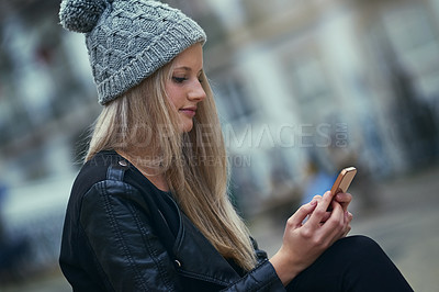 Buy stock photo Shot of an attractive woman using a mobile phone in the city