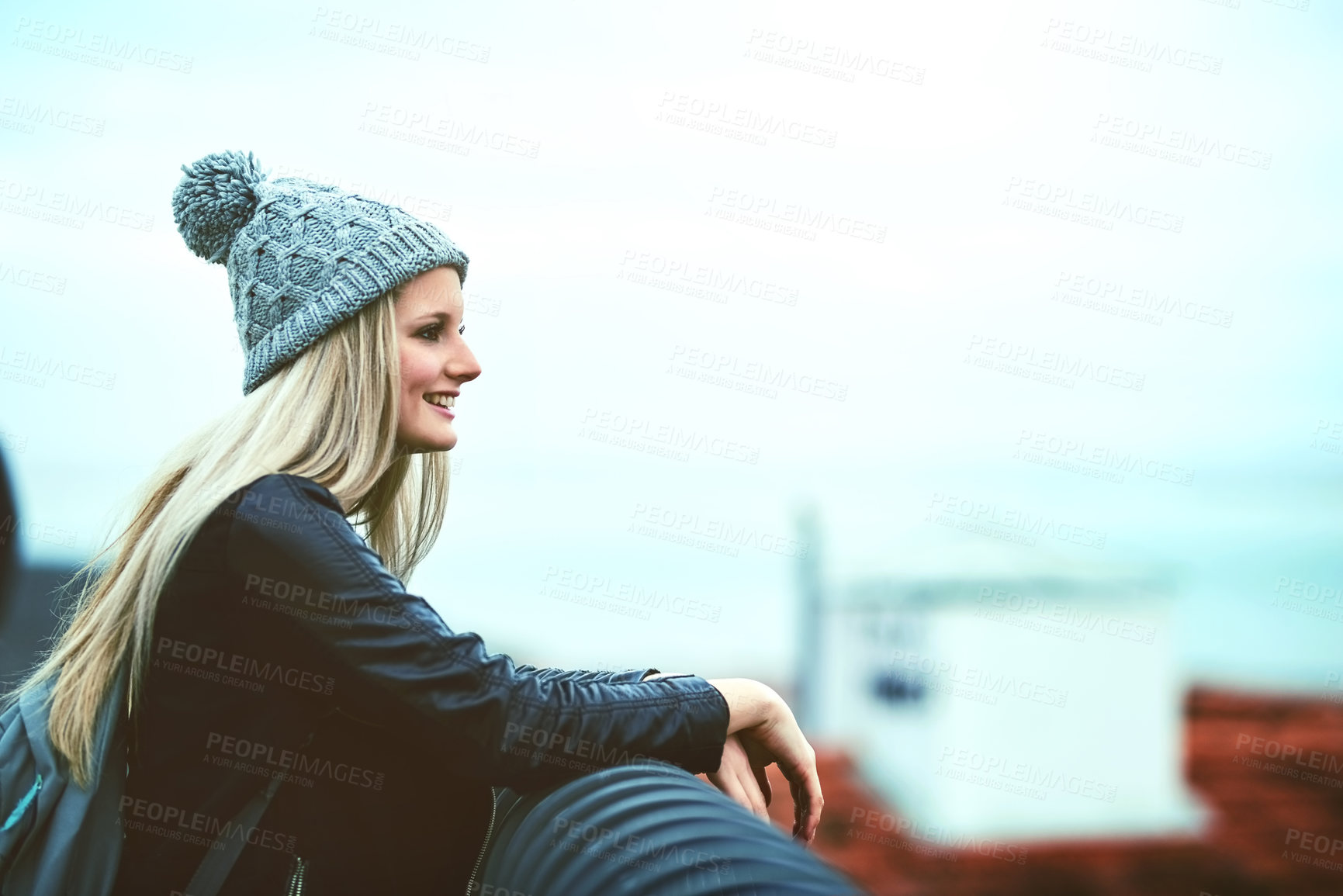 Buy stock photo Shot of a young woman looking at the city view from a bridge