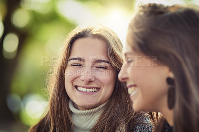 Buy stock photo Cropped shot of two attractive young women spending the day outdoors