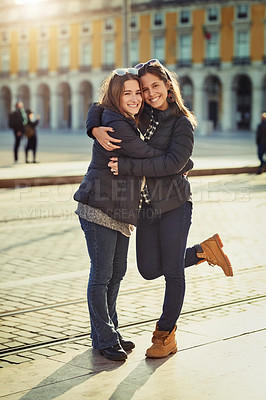 Buy stock photo Full length portrait of two attractive young women spending a day in the city