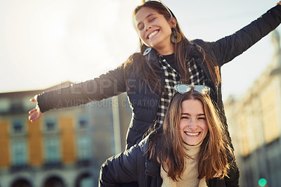 Buy stock photo Cropped portrait of two attractive young women spending a day in the city