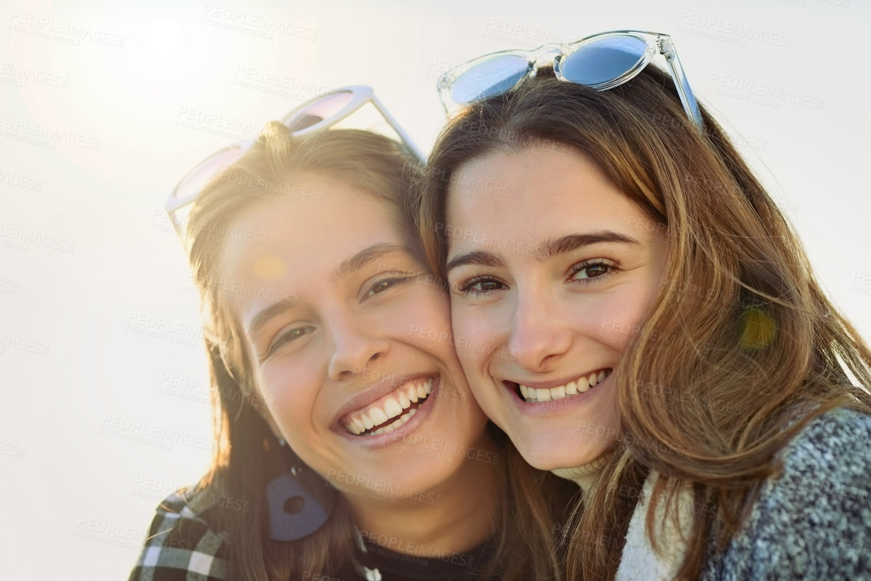 Buy stock photo Cropped portrait of two attractive young women spending the day outdoors