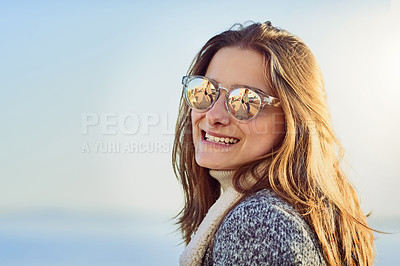 Buy stock photo Happy woman, sunglasses and smile with fashion or accessory by beach or ocean coast in nature. Young, female person or tourist with travel in joy for style, summer season or holiday weekend by sea