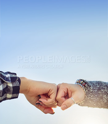 Buy stock photo Cropped shot of two unrecognizable women fist bumping outdoors