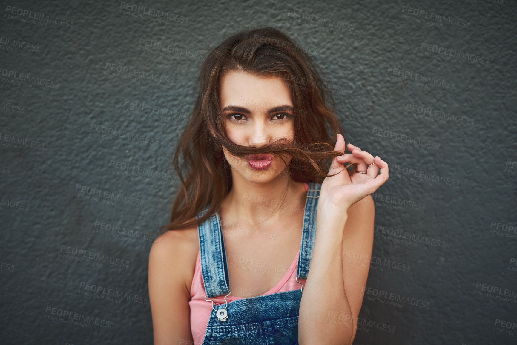 Buy stock photo Woman, portrait and hair mustache with playful, fun and kissing face on gray background wall. Girl, silly smile and relaxing pout with care, happiness and comic joke for funky urban gen z fashion