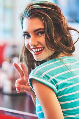 Buy stock photo Peace sign, portrait and retro with woman in diner to relax for friendly hospitality or service. Face, makeup and smile with happy customer person in cafe or restaurant for break or visit on weekend