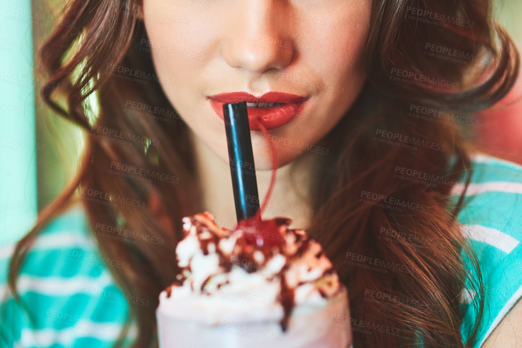 Buy stock photo Cropped shot of an unrecognizable woman drinking a milkshake in a diner