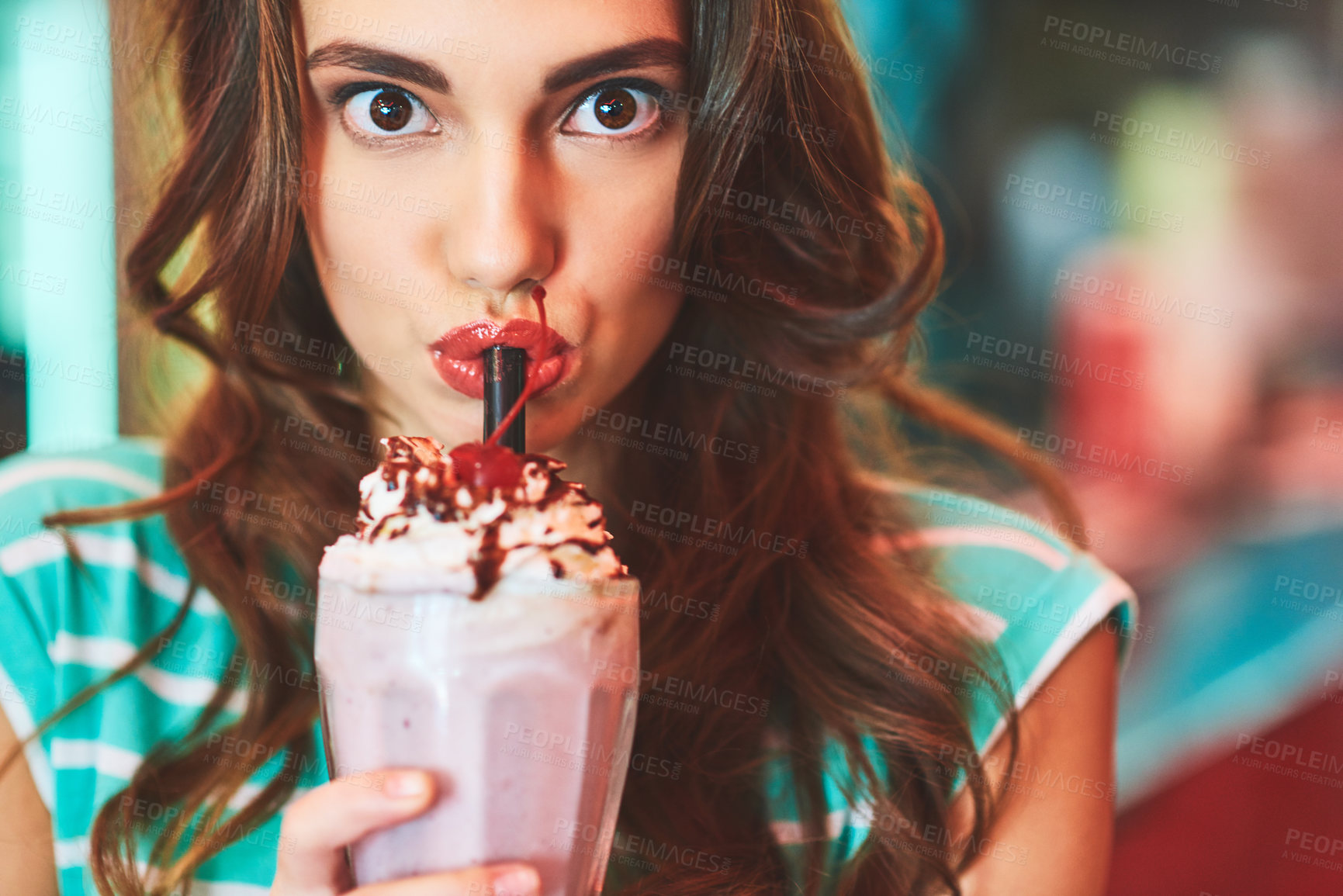 Buy stock photo Shot of a beautiful young woman drinking a milkshake in a diner