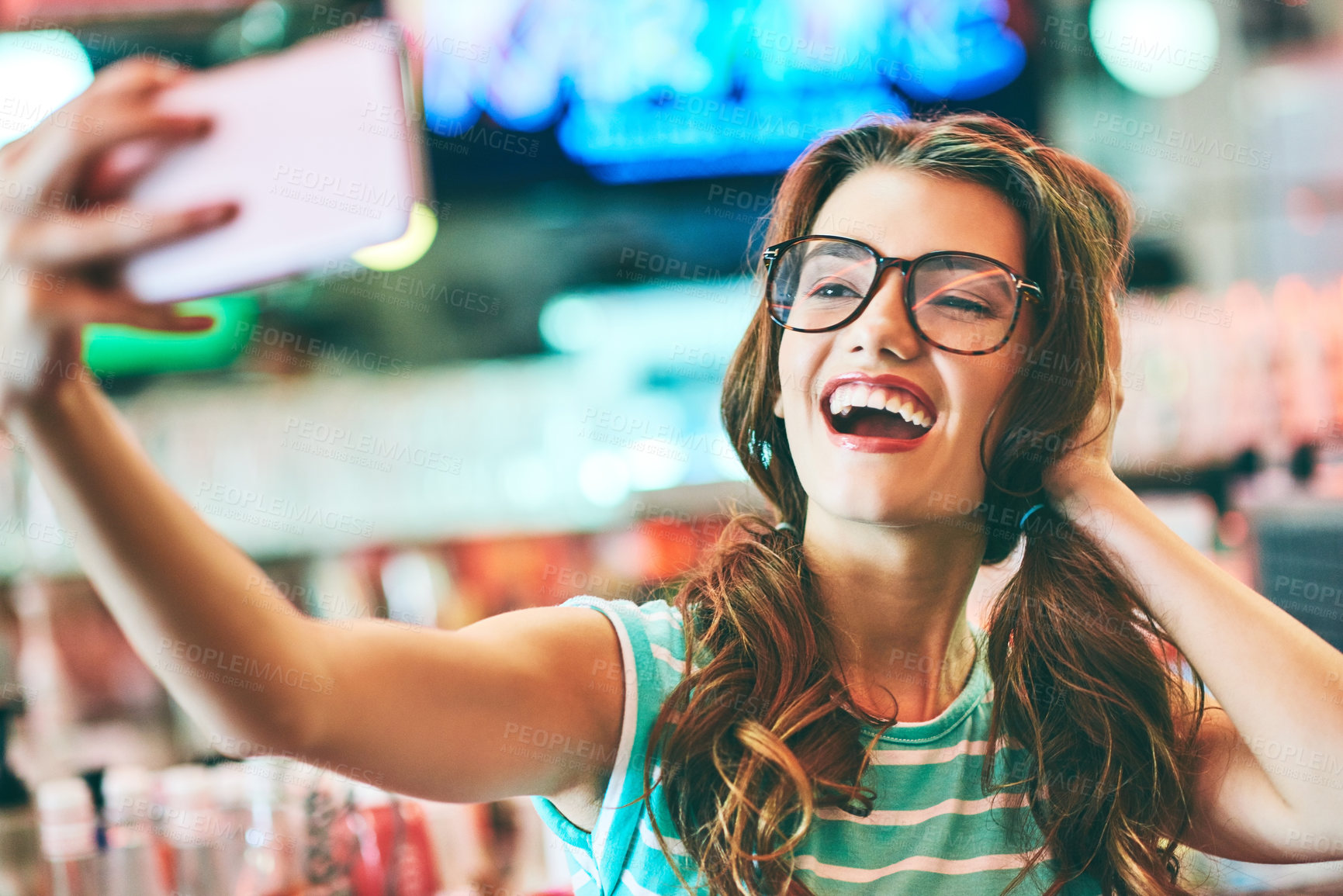 Buy stock photo Shot of a beautiful young woman taking a selfie in a diner