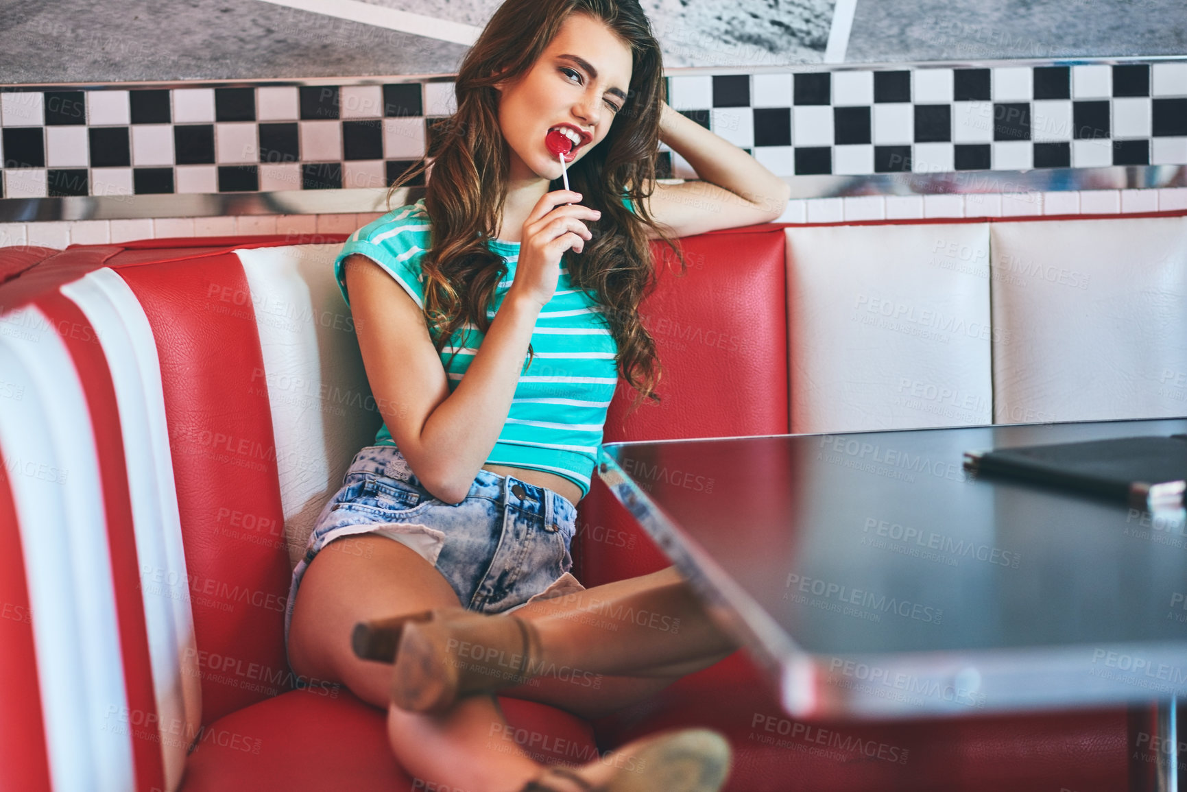 Buy stock photo Shot of a beautiful young woman in a diner