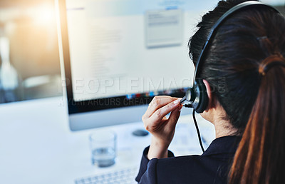 Buy stock photo Rearview shot of a young woman working in a call centre