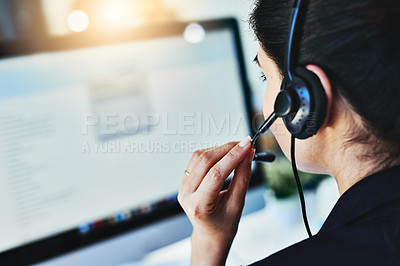 Buy stock photo Rearview shot of a young woman working in a call centre