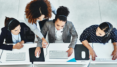 Buy stock photo High angle shot of a group of women working in a call centre