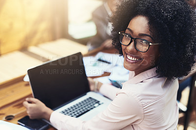 Buy stock photo Portrait of an attractive young businesswoman working on a laptop outdoors