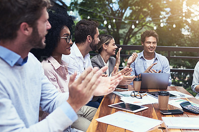 Buy stock photo Shot of a group of colleagues applauding during a meeting at a cafe