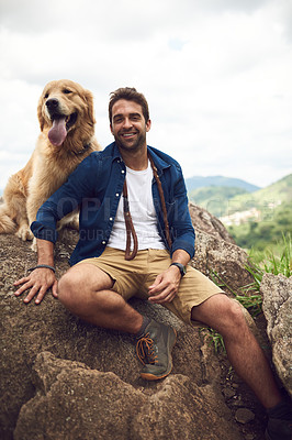 Buy stock photo Cropped portrait of a handsome young man and his dog taking a break during a hike in the mountains