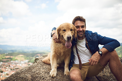 Buy stock photo Cropped portrait of a handsome young man and his dog taking a break during a hike in the mountains