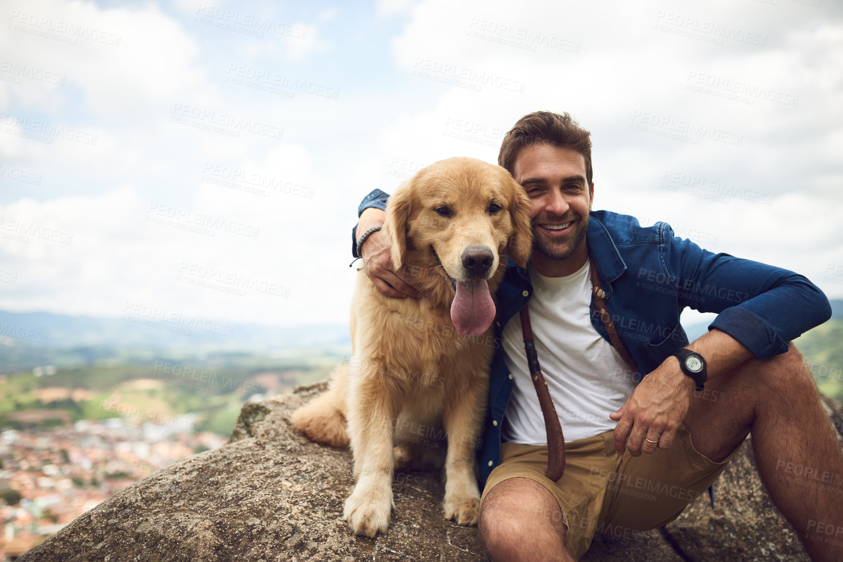 Buy stock photo Cropped portrait of a handsome young man and his dog taking a break during a hike in the mountains