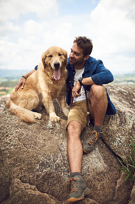 Buy stock photo Full length shot of a handsome young man and his dog taking a break during a hike in the mountains