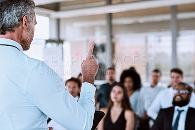 Buy stock photo Cropped shot of a mature businessman delivering a speech during a conference