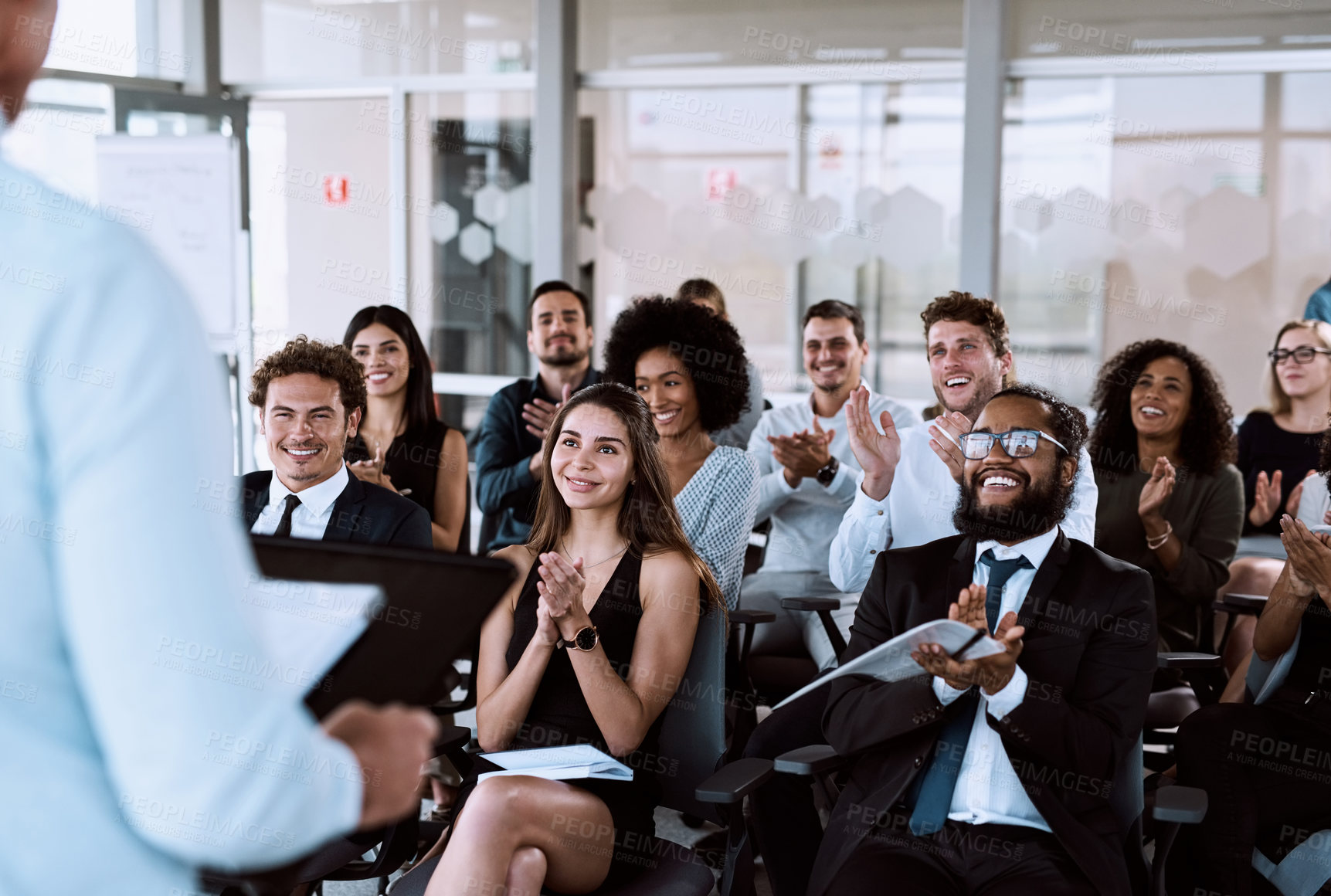 Buy stock photo Shot of a group of businesspeople clapping during a conference