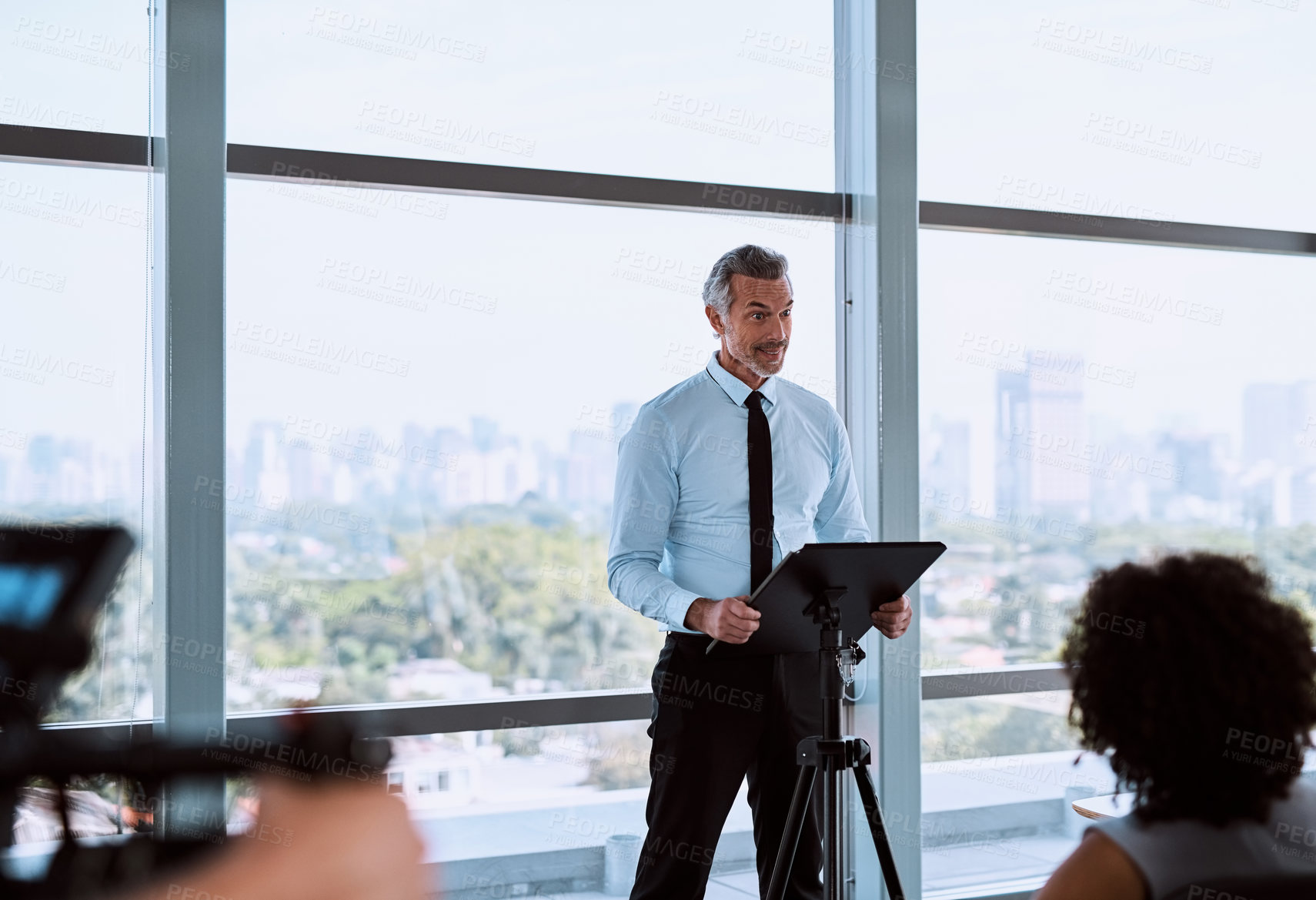 Buy stock photo Shot of a mature businessman delivering a speech during a conference