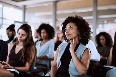 Buy stock photo Shot of a businesswoman listening intently during a conference