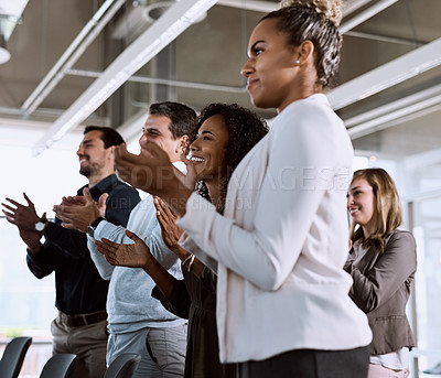 Buy stock photo Shot of a group of businesspeople clapping during a conference