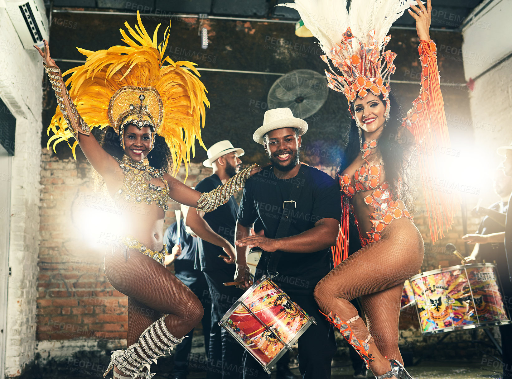 Buy stock photo Cropped portrait of two beautiful samba dancers performing at Carnival with their band
