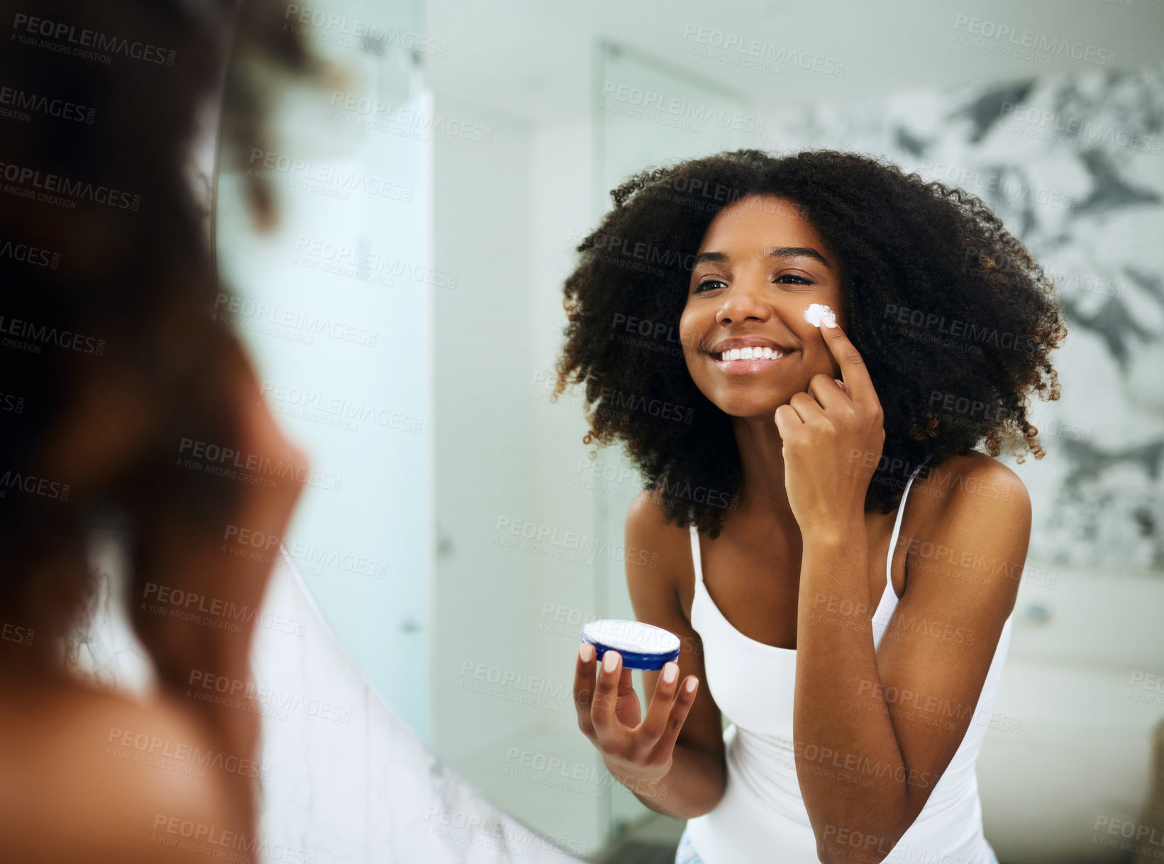 Buy stock photo Skincare, bathroom mirror and black woman with cream, smile and morning dermatology routine. Health, wellness and luxury skin care at home, girl in reflection with lotion on face for facial treatment
