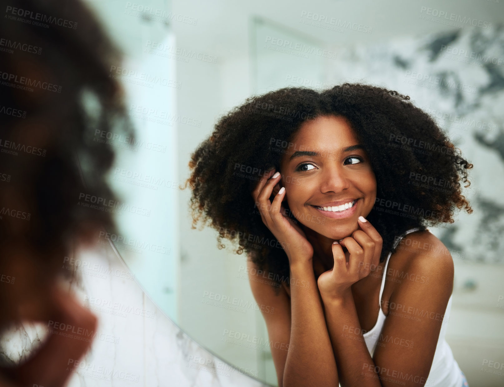 Buy stock photo Shot of an attractive young woman looking at her face in the mirror at home