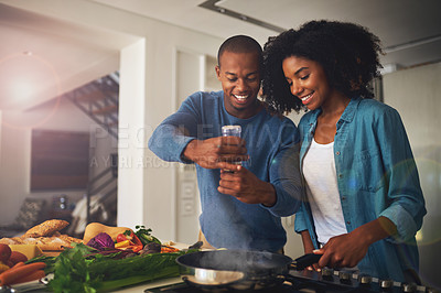 Buy stock photo Shot of a cheerful young couple taking a photo of the ingredients of the meal they are about to prepare together at home