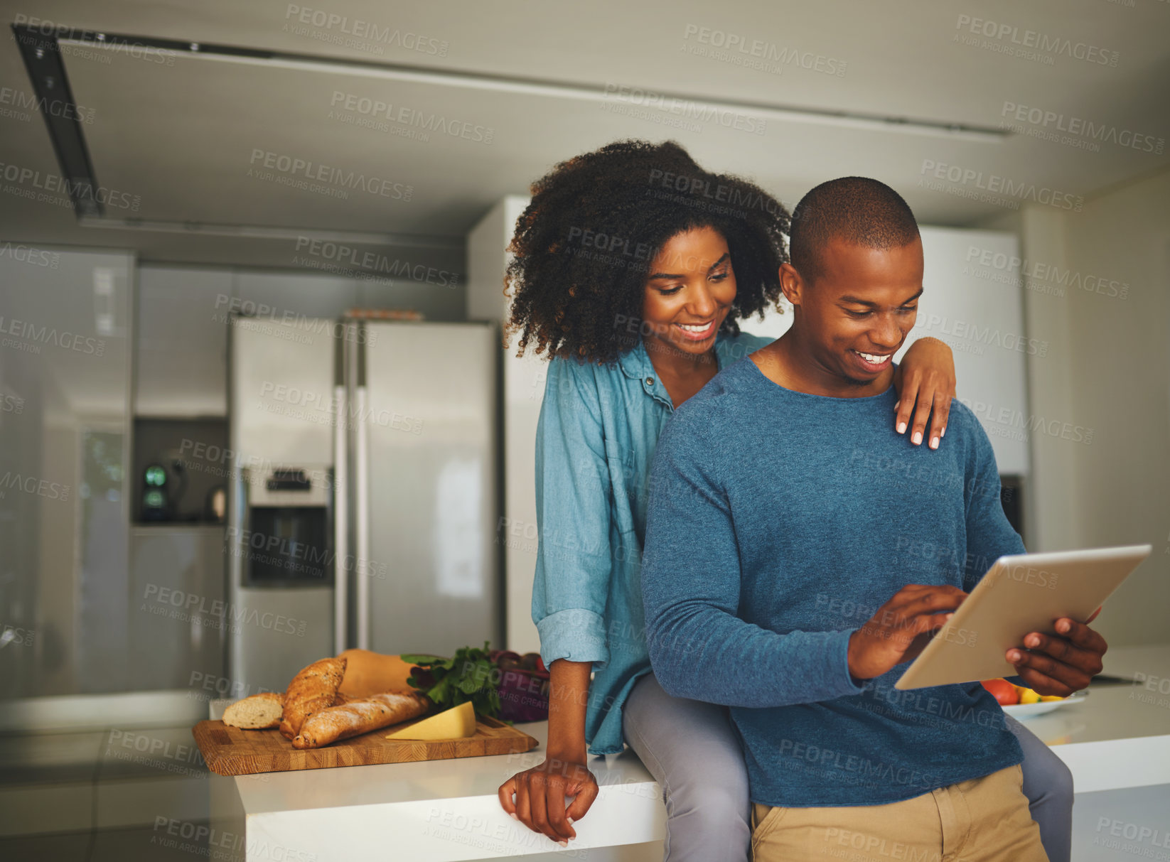 Buy stock photo Black couple, happy and tablet in kitchen with love, hug and reading website for dinner recipe. Man, woman and tech at home for social media, viral food hack and support in relationship for bonding