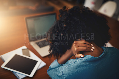 Buy stock photo Rearview shot of a young woman holding her neck in pain while working at home