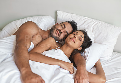 Buy stock photo Cropped shot of a young married couple sleeping in bed at home