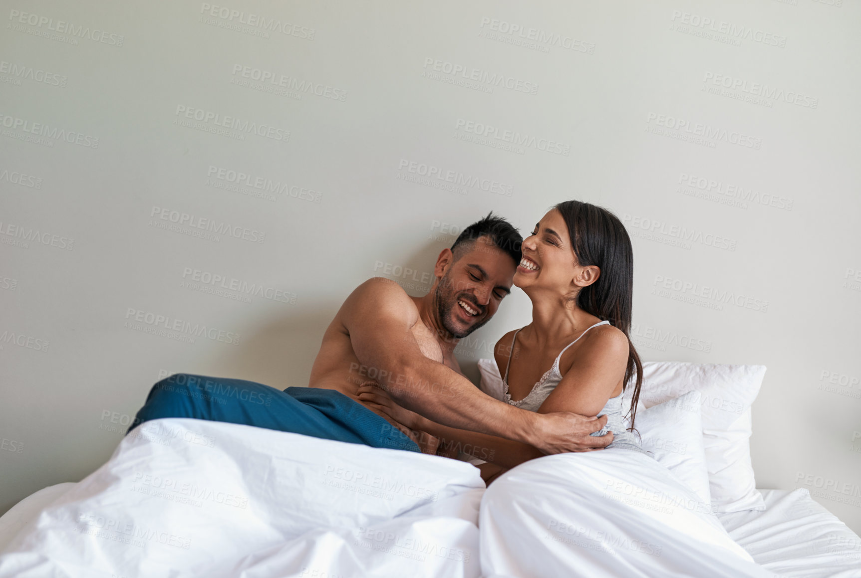 Buy stock photo Love, tickle and happy with couple in bedroom for romance, valentines day and marriage. Honeymoon, getaway and morning with man and woman at home or staycation for anniversary retreat and laugh