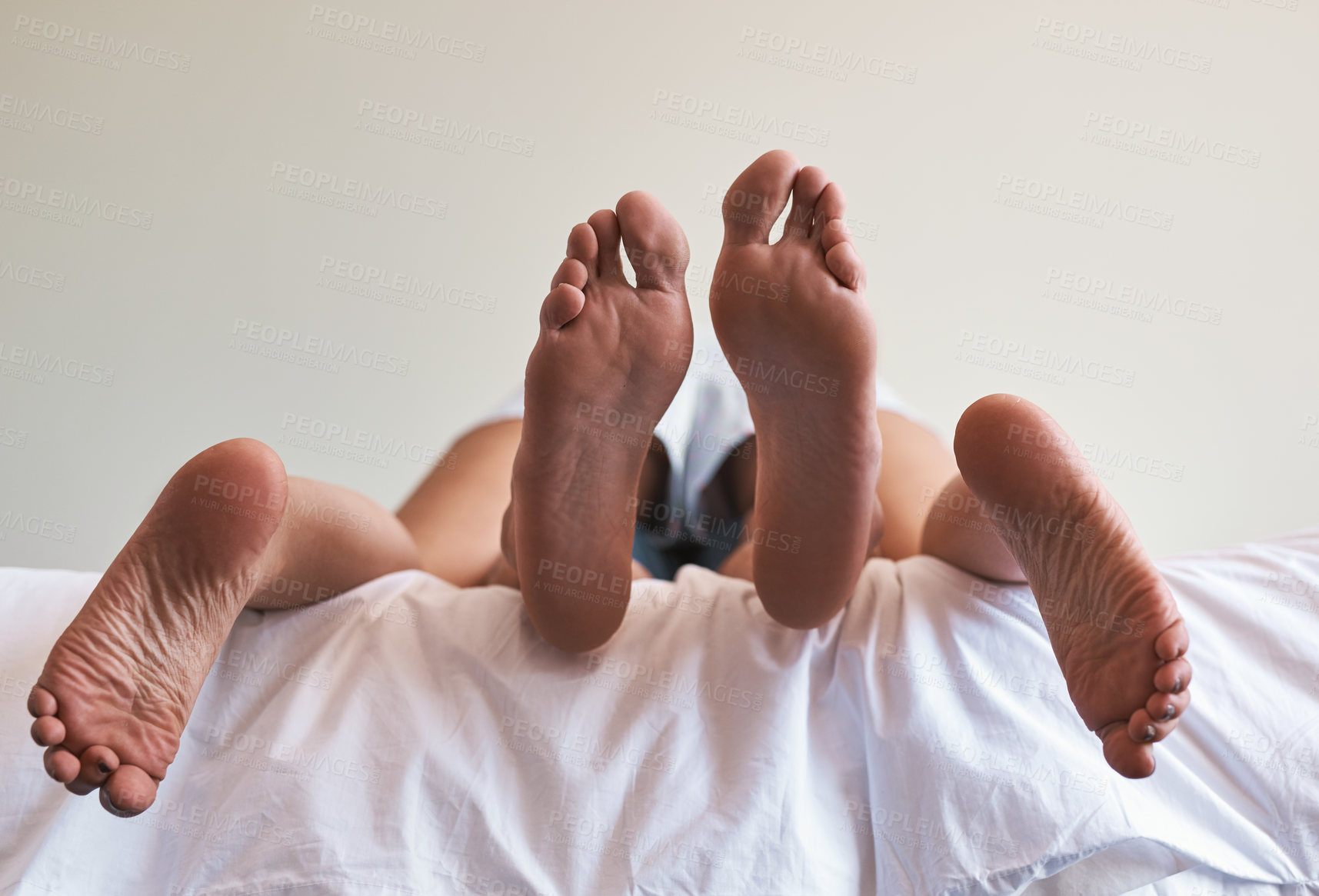 Buy stock photo Relax, cuddle and feet of couple in bedroom for bonding, hotel getaway and sleeping together. Calm, peace and vacation with closeup of people at home for marriage, honeymoon and relationship