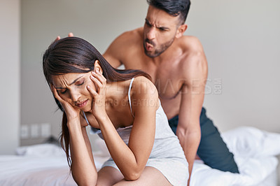 Buy stock photo Cropped shot of a husband arguing while his wife covers her ears in their bedroom at home