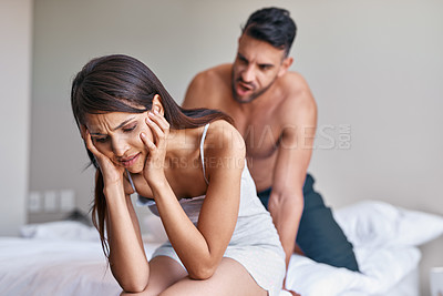 Buy stock photo Cropped shot of a husband arguing while his wife covers her ears in their bedroom at home