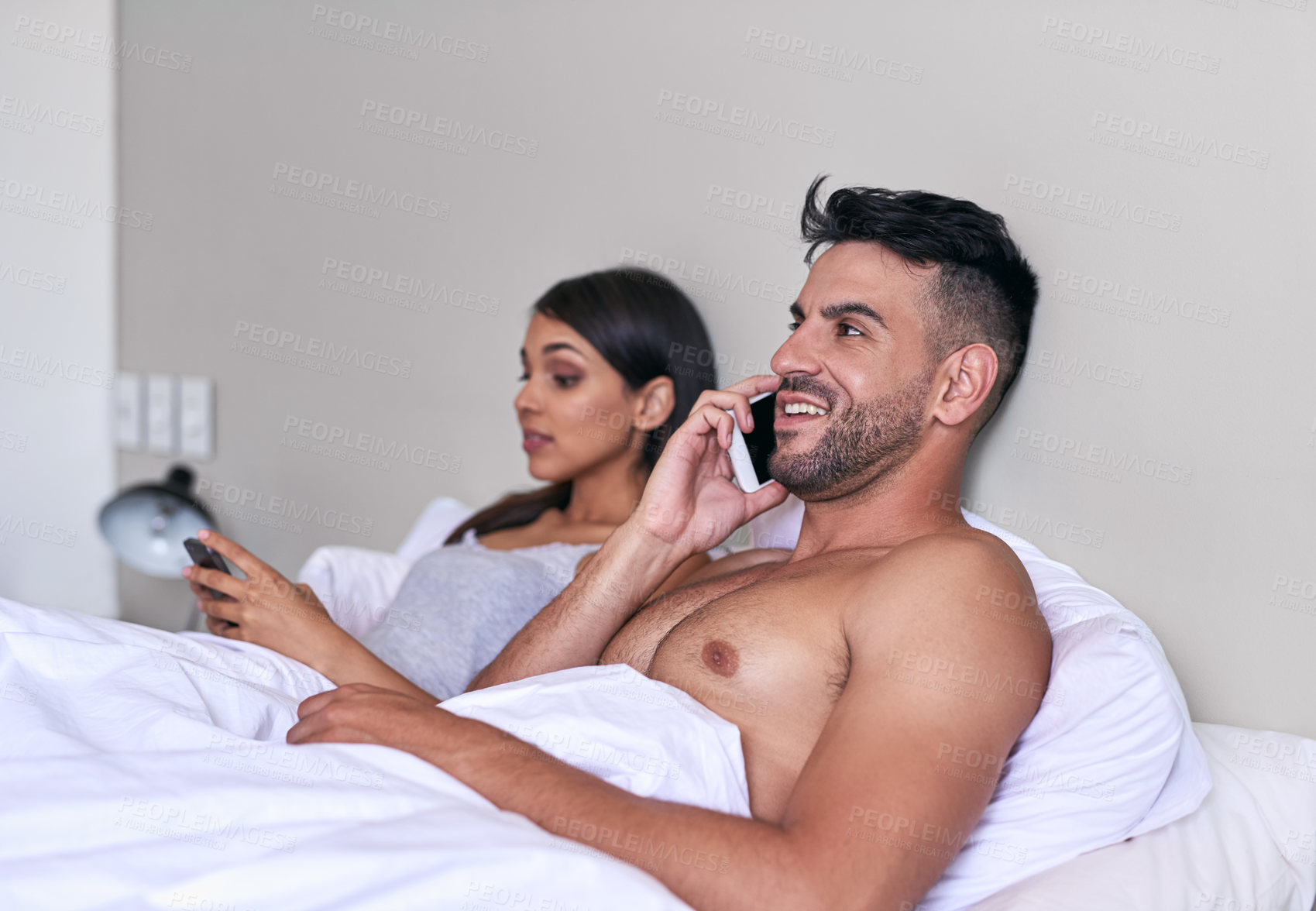 Buy stock photo Couple, phone call and bedroom for communication, conversation or happiness in relationship or marriage. Woman, man and technology with mobile app, social media or announcement for connection in home