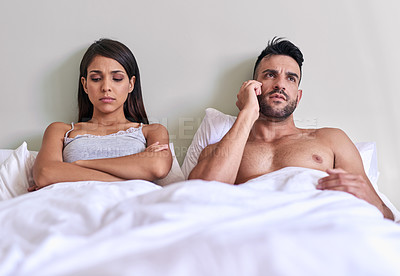 Buy stock photo Cropped shot of a husband on a call while his wife is upset in their bed at home