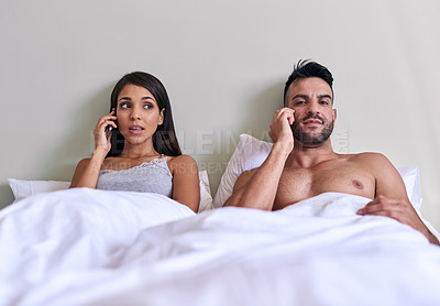 Buy stock photo Cropped shot of a young married couple on a call in their bed at home