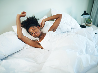 Buy stock photo Shot of a young beautiful woman waking up and stretching in her bed at home
