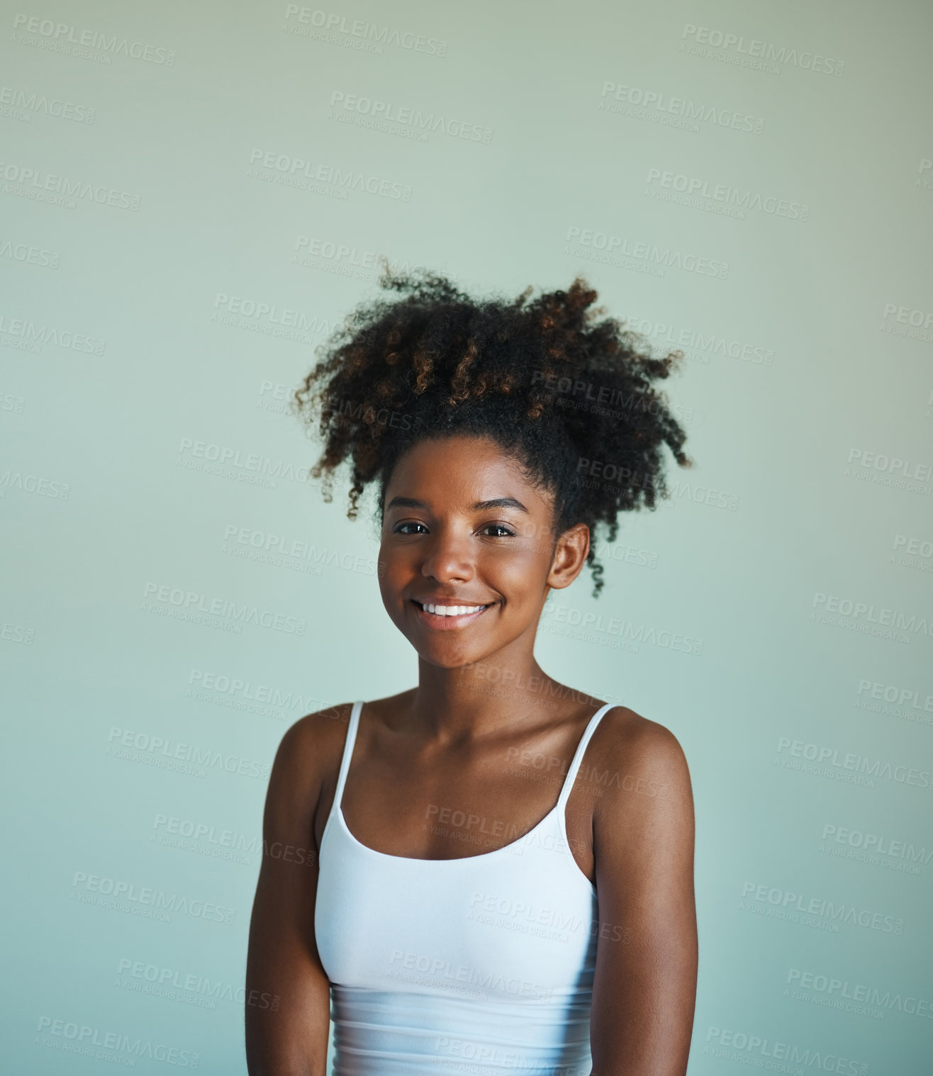 Buy stock photo Studio shot of a beautiful, fresh faced young woman posing against a green background