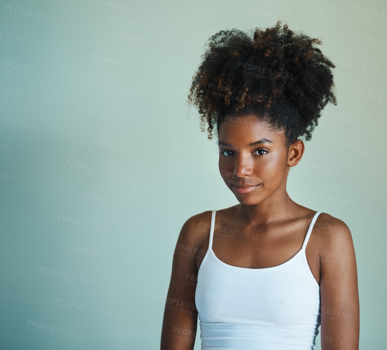 Buy stock photo Studio shot of a beautiful, fresh faced young woman posing against a green background