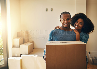 Buy stock photo Portrait, new house and couple with box in living room for moving, real estate or property investment. Lens flare, black man and happy woman with cardboard for smile, mortgage or relocation in home