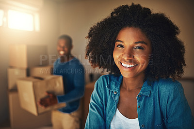 Buy stock photo Portrait of a cheerful young couple packing up boxes together on moving day inside at home