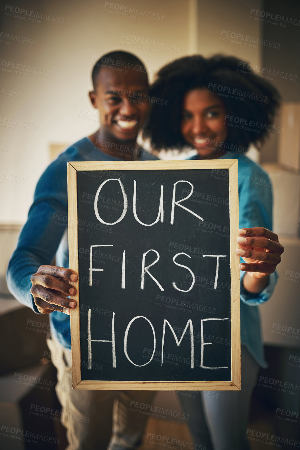 Buy stock photo Moving, couple and portrait with poster in new house for relocation, sign and milestone in marriage. Happy, man and woman with words on board for property investment goals, mortgage and first home