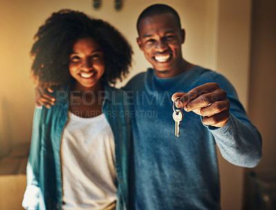Buy stock photo Portrait of a cheerful young couple standing together while holding up a pair of keys to their new home
