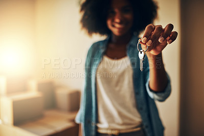 Buy stock photo Portrait of a cheerful young woman standing alone while holding up a pair of keys to their new home